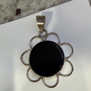 Sterling silver floral style pendant with black onyx center
